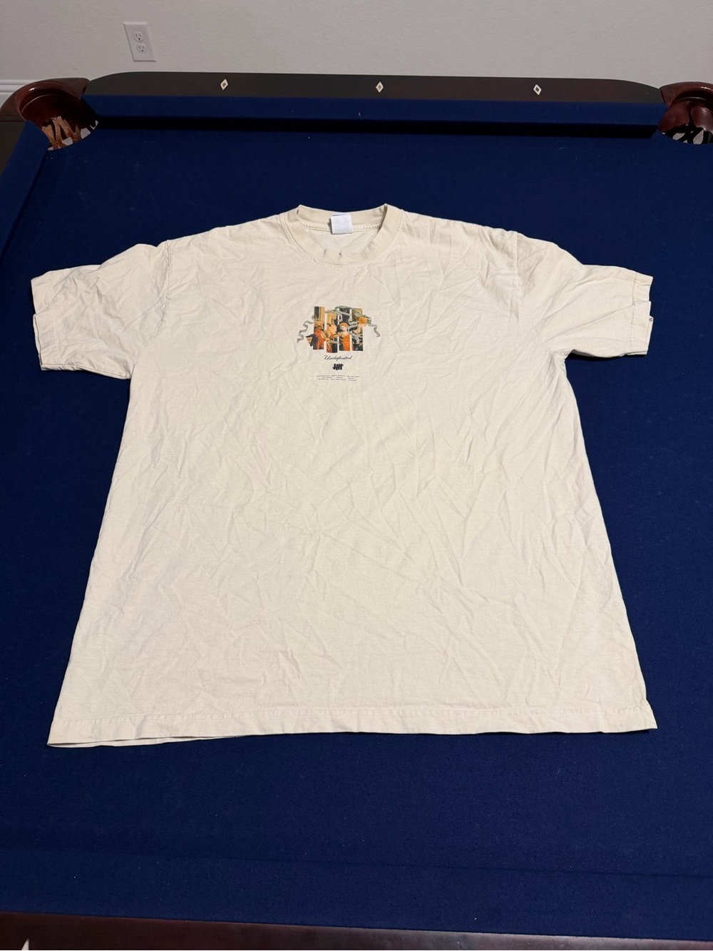 Undefeated Cream Short Sleeve Graphic Tee with Small Center Print